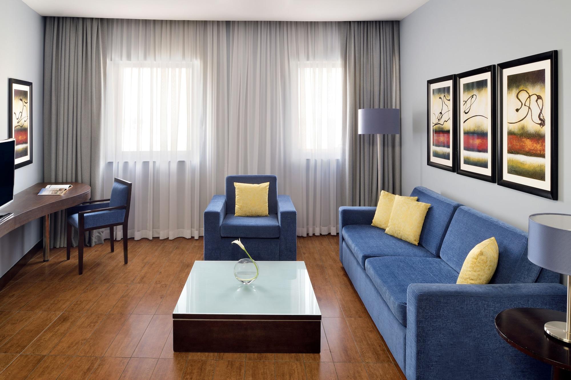 Moevenpick Hotel Apartments Al Mamzar Dubai Exterior foto A living room with a sofa